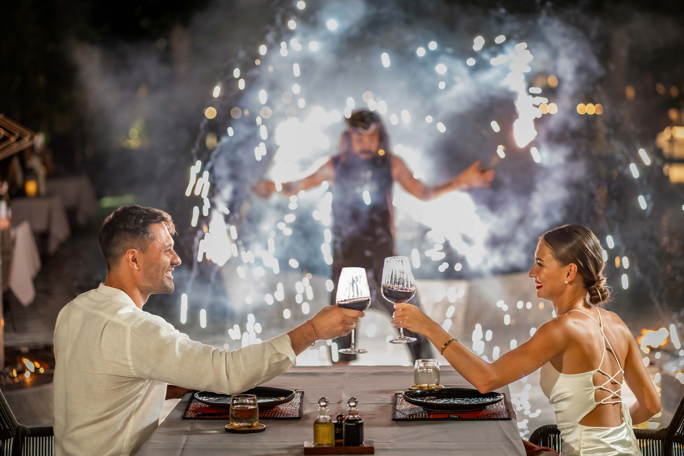 Fire show performance beside diners raising a toast