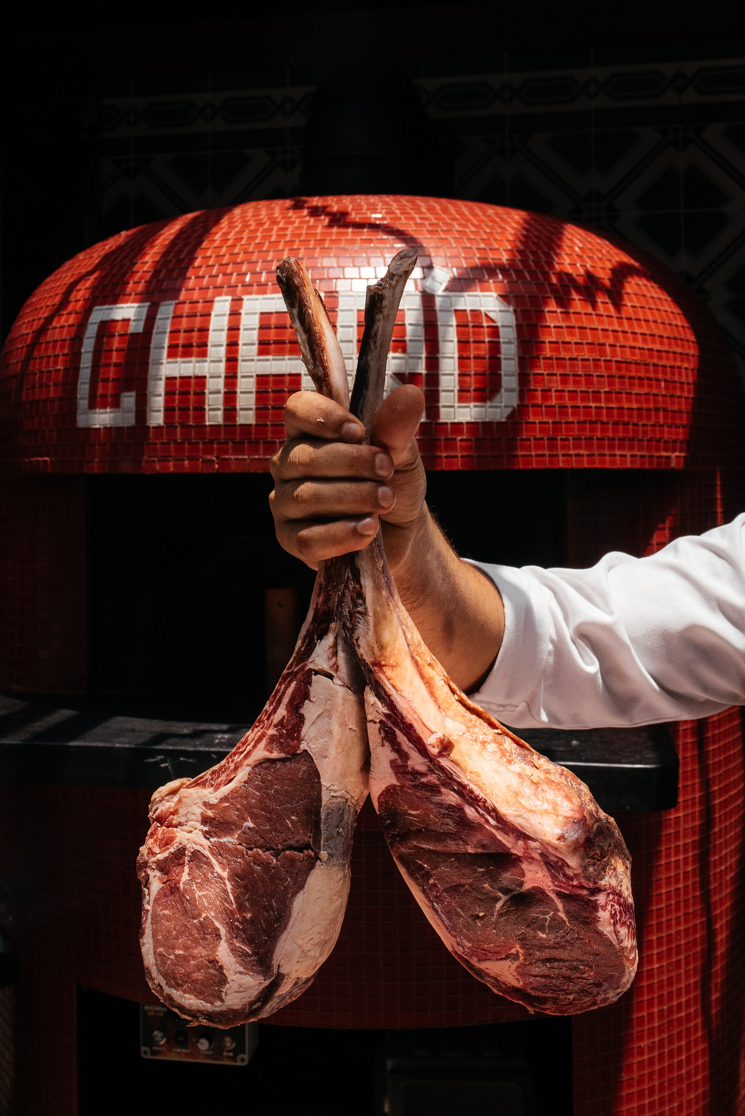 Chef presenting a premium tomahawk cut